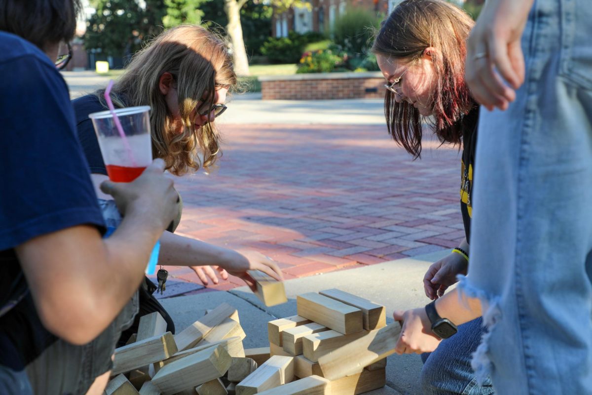 Students scrambling together to rebuild the tower for the next game of Jenga. Students had the opportunity to create their own mocktails and play games at the Aug. 21 event.