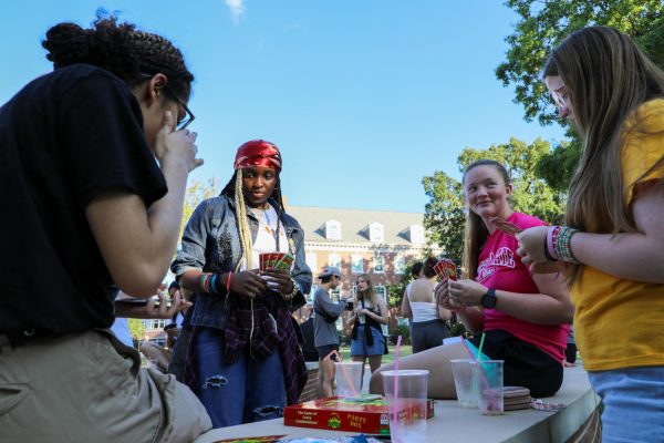 A group of students play the card game "Apples to Apples" after finishing their mocktails. Wichita Honors Events and Activities hosted the Aug 21. event. 