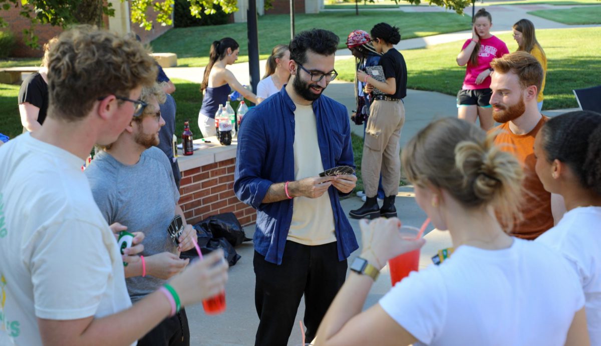 A group of students play UNO after creating their own mocktails. The event featured games and crafts. 