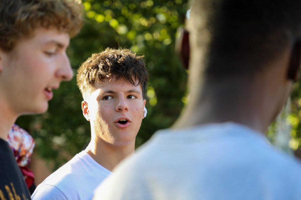 Freshman Bryce Hammer arguing about the rules of UNO. The Mocktail event featured various card games as a way for students to socialize.