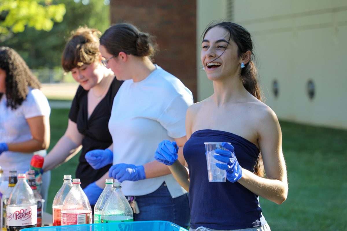 Junior Dayana Almeida laughing as she takes an order for a mocktail. The event was hosted by the student organization WHEAT for students to relax. 