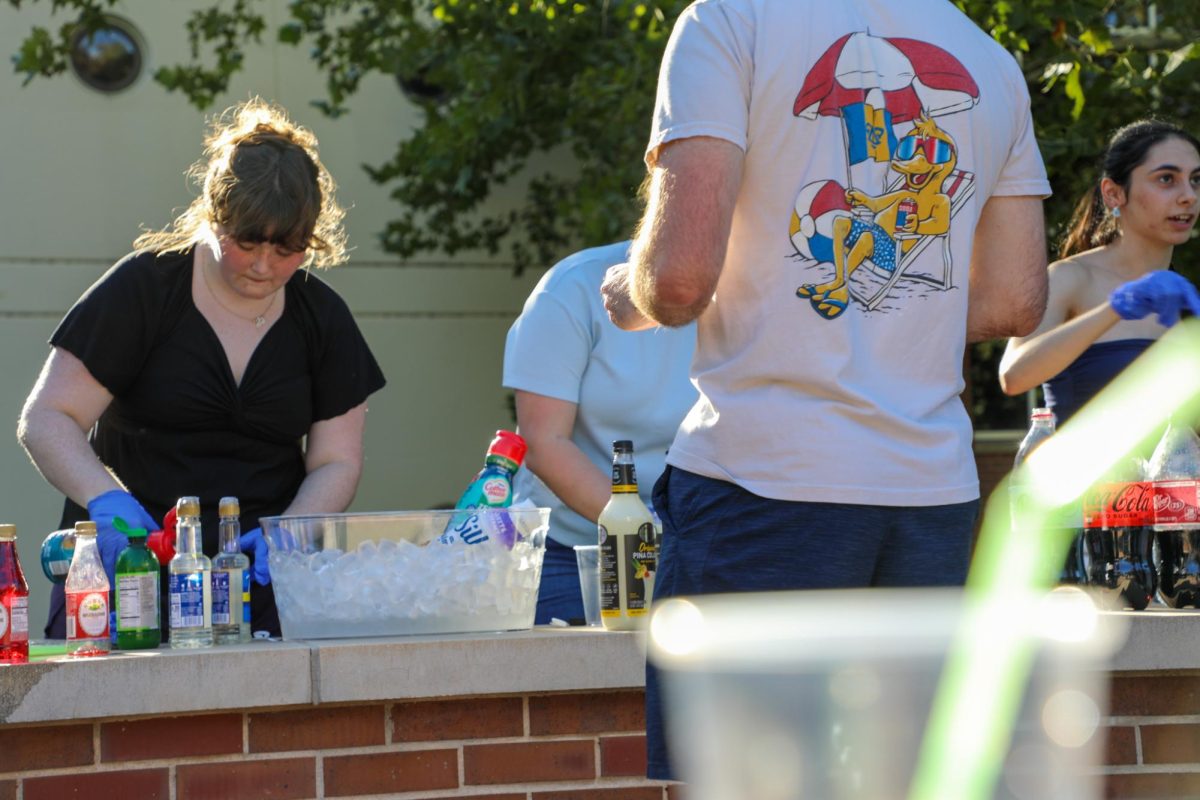 A student waits as a drink is prepared for him. The student organization WHEAT hosted a create your own mocktail event on Aug. 21. 