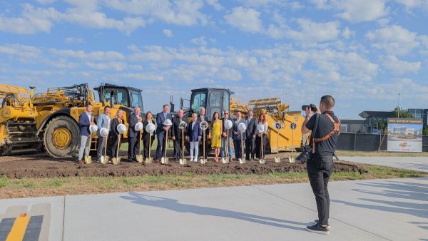 WSU Tech and Wichita State leaders pose for a photo alongside local, state and national officials and others at the groundbreaking ceremony for an expansion to the National Center for Aviation Training. The ceremony was held on Aug. 22 with construction to begin the following week. 