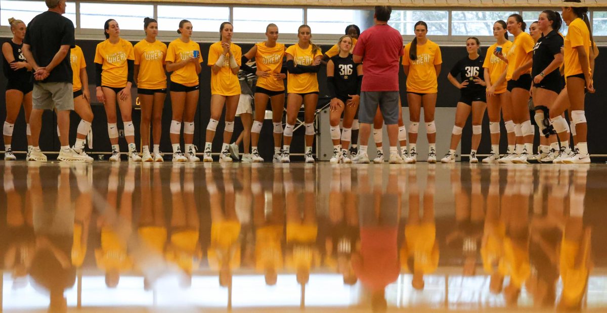 Wichita State's volleyball team listens to head coach Chris Lamb at the end of practice on Aug. 4. The Shockers open their season at home for the first time since 2007.