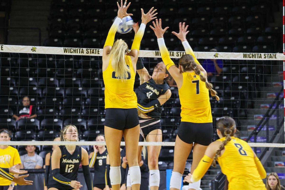 Sophomore Allie Paulsen and freshman Jenna Cubbage try to block junior Sydney Dunning's spike. WSU held its Black and Yellow scrimmage on Aug. 23.