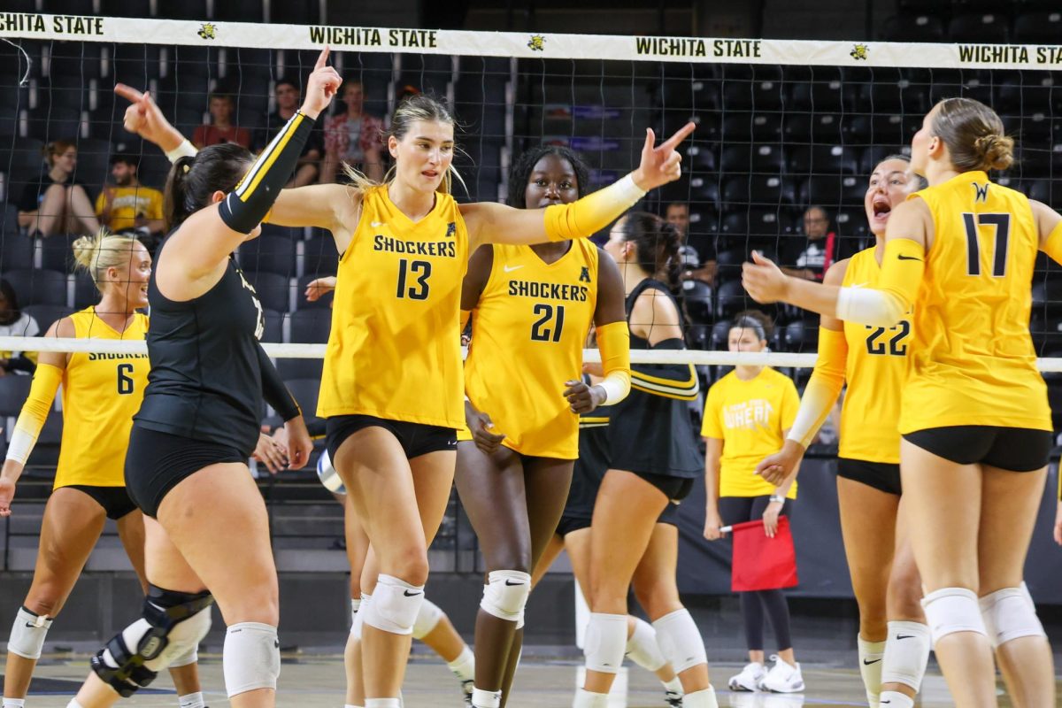 The Yellow team celebrates after scoring a point in the Black and Yellow scrimmage on Aug. 23. The Yellow team averaged 20 points a set.