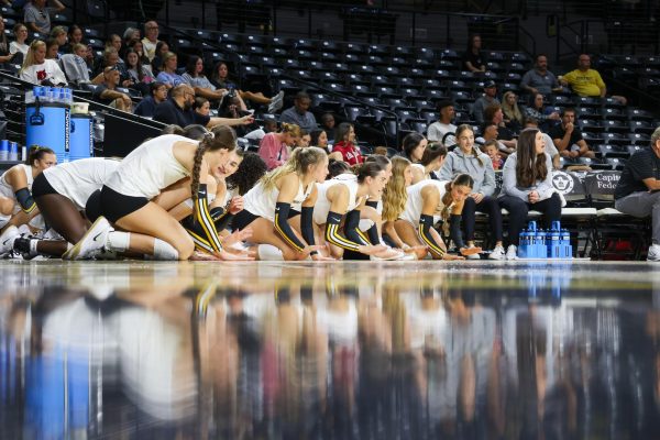 Wichita State's bench gets down on their knees and slaps the ground while Arkansas is serving. Arkansas ended with six service errors on Aug. 31.