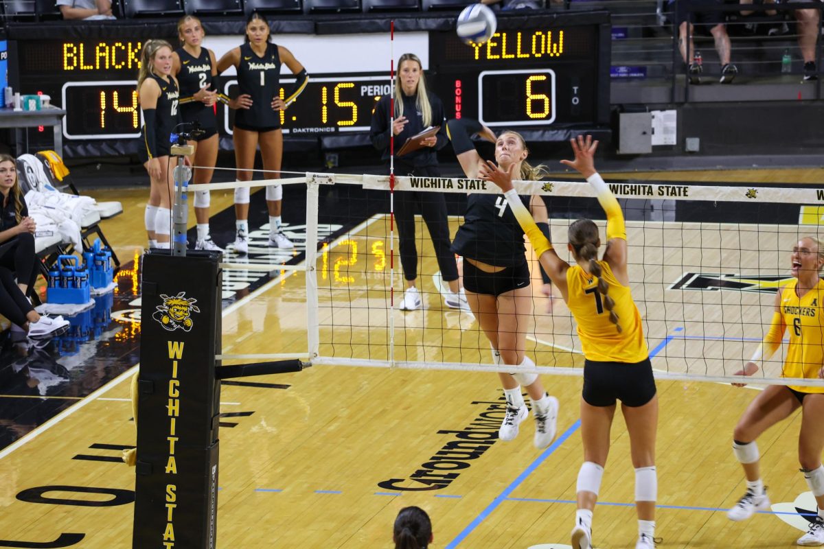 Senior outside hitter Brooklyn Leggett tries spiking the ball for a kill on Aug. 23. Leggett was the only Shocker named to the preseason All-American Conference team.