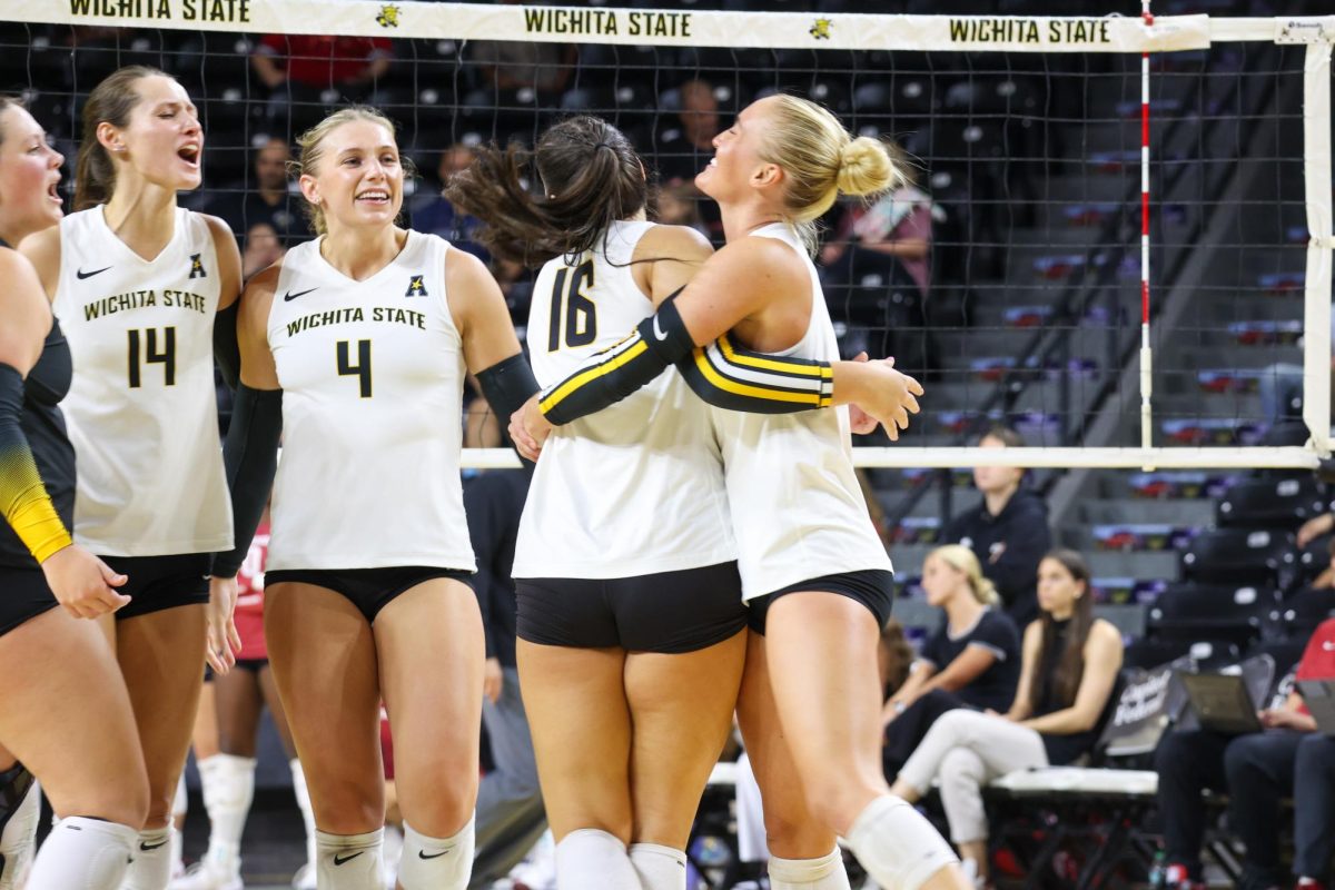 Senior libero Katie Galligan hugs junior setter Jordan Heatherly after she got an ace on Aug. 31. The Shockers had six aces against Arkansas.