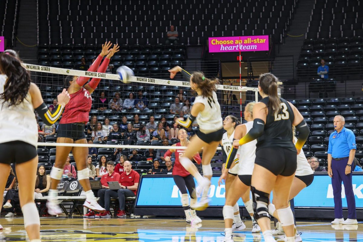 Junior middle blocker Maddie Wilson's shot is blocked by an Arkansas defender. The Razorbacks blocked 11 shots on Aug. 31.