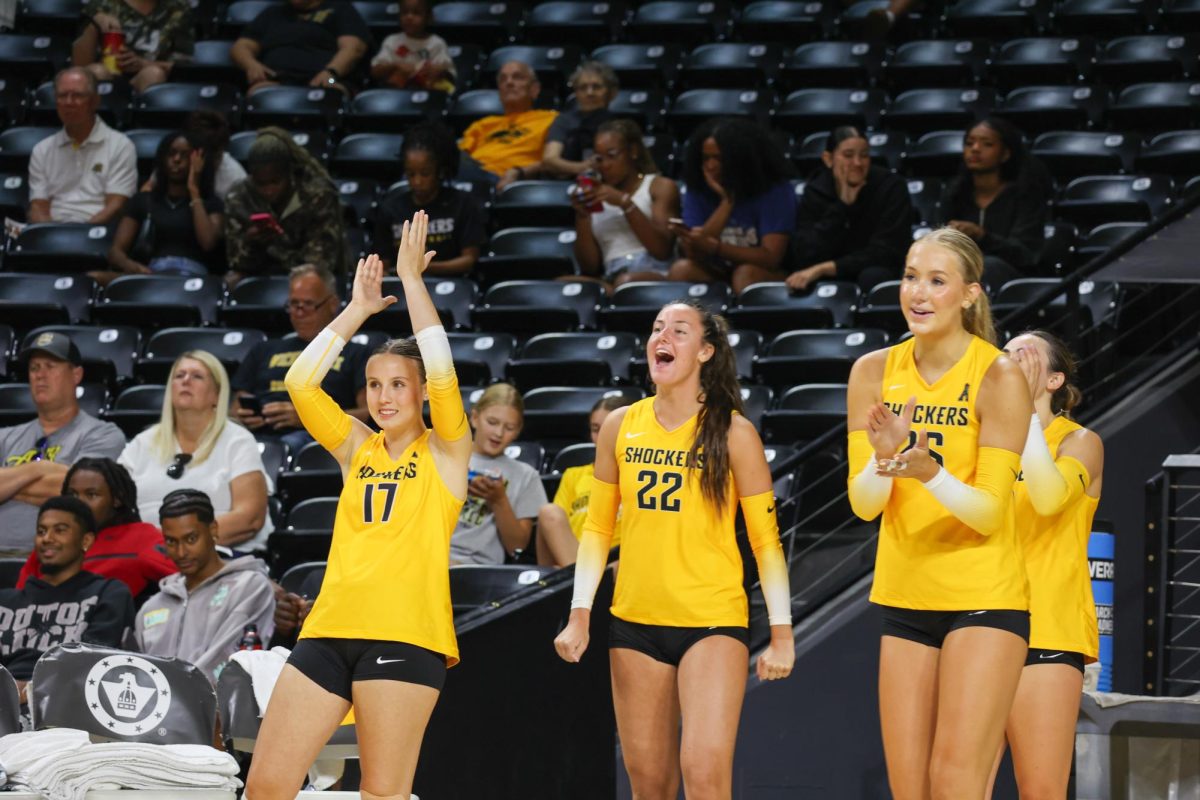 The Yellow team's bench celebrates a point on Aug. 23. The Black and Yellow scrimmage was a preseason intersquad scrimmage.