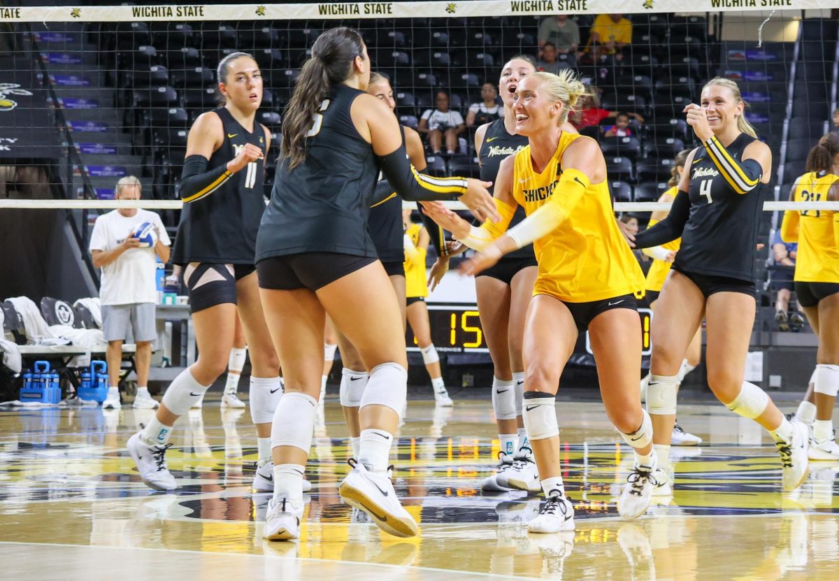 Senior libero Katie Galligan high-fives with junior setter Jordan Heatherly after she made a save for the Black team on Aug. 23. Heatherly is a transfer from Memphis.