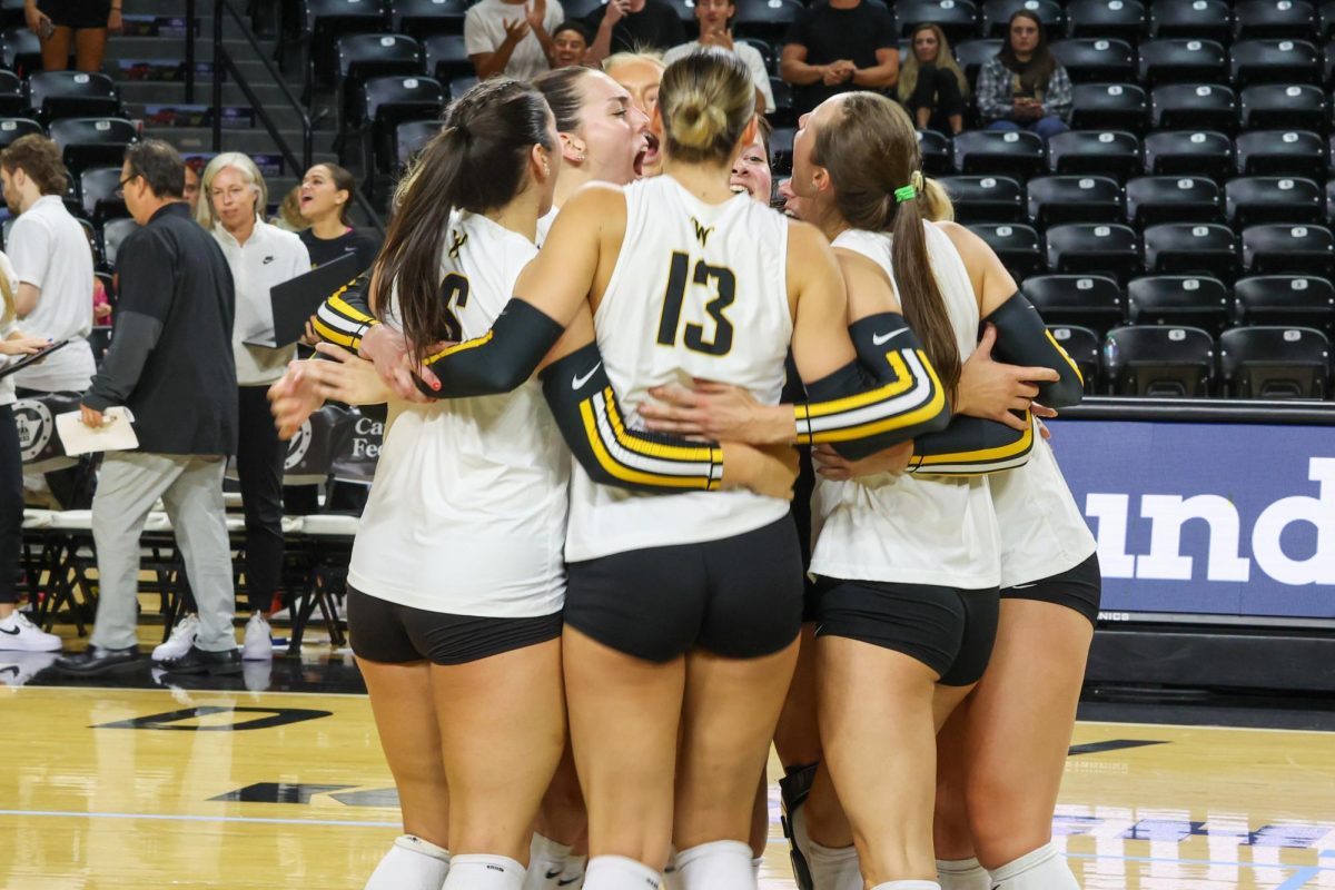 The Shockers hug after beating Arkansas in the fifth set. The Shockers won 15-7 in the fifth and final set on Aug. 31.