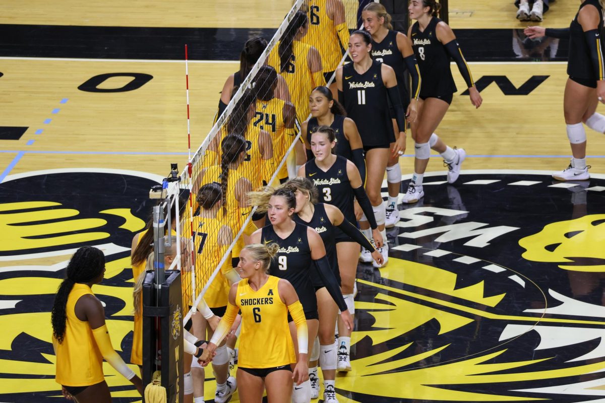The Black and Yellow teams high-five after the end of the fifth set on Aug. 23. The Black team won WSU's intersquad scrimmage, 4-1.