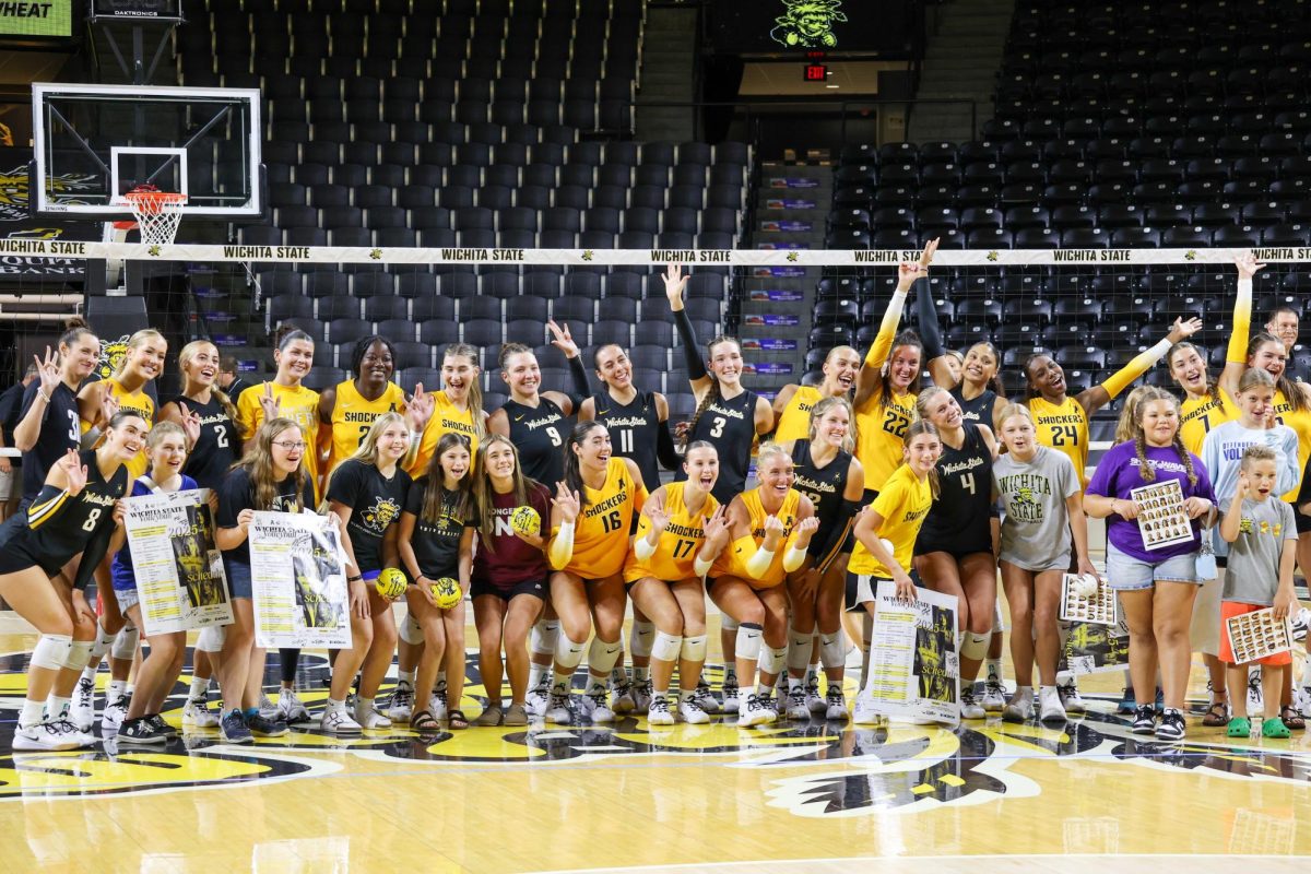 Wichita State's volleyball team takes a picture with a group of young fans at the end of the Black & Yellow scrimmage on Saturday. The Shockers season starts on Aug. 29.