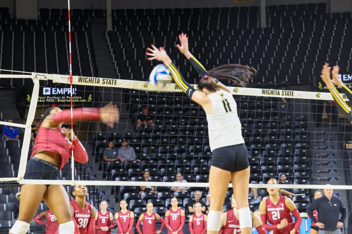 Junior outside hitter Sydney Dunning jumps to block a shot on Aug. 31. Dunning had one block in the win against Arkansas.