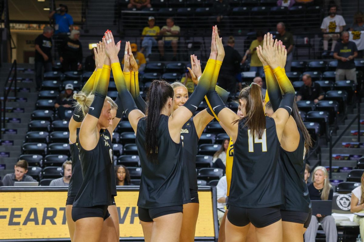 The Shocker volleyball starters interlock hands before the match against Kennesaw State on Aug. 29. WSU's starting lineup was made up of five returners and two newcomers.