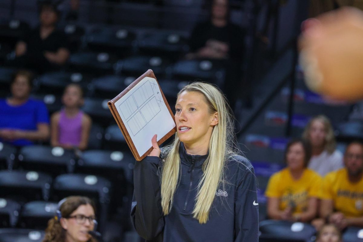WSU volleyball assistant coach and recruiting coordinator Katie Zimmerman talks to her team during the Black and Yellow scrimmage. Zimmerman coached the Black team on Aug. 23.