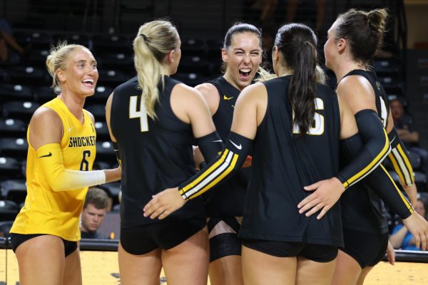 The Black team celebrates a fourth set win in Wichita State volleyball's Black and Yellow scrimmage. The Black team won four sets to one on Aug. 23.