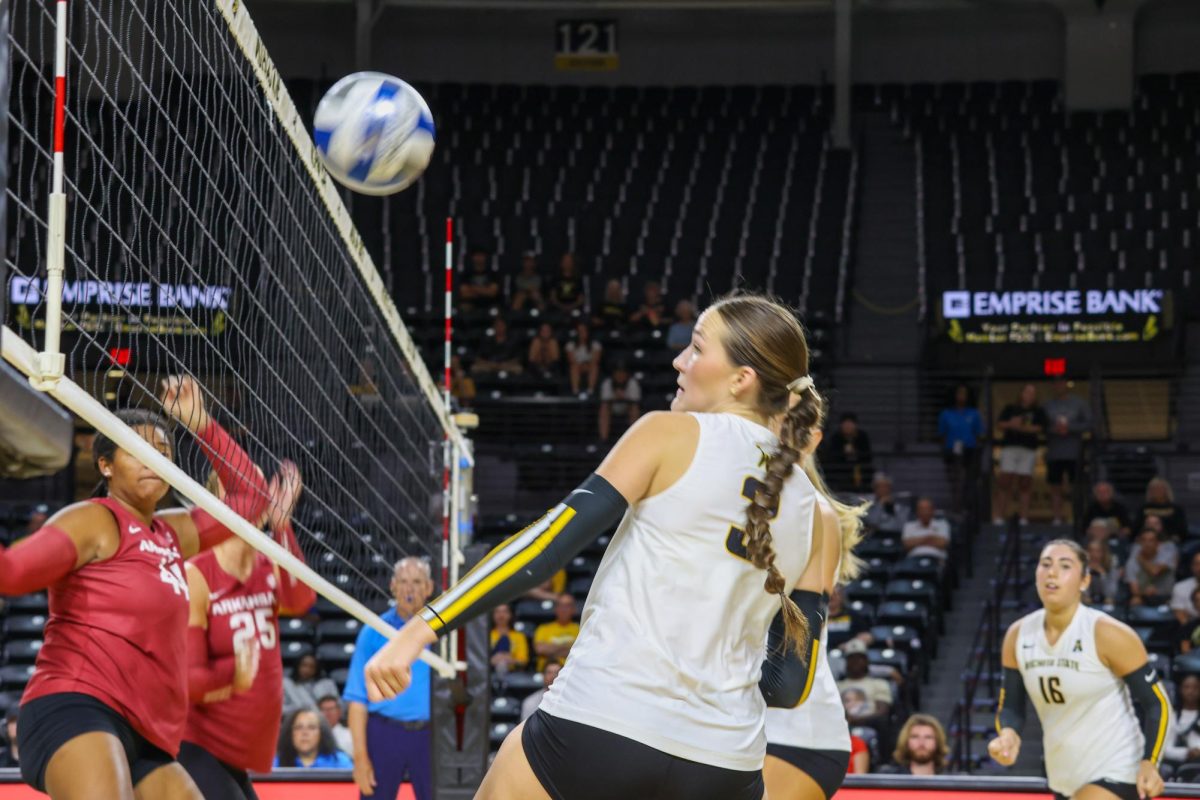 Freshman outside hitter Olivia Cohee ducks out of the way of the ball on Aug. 31. Cohee is one of 10 ten freshmen on the Shockers' roster.