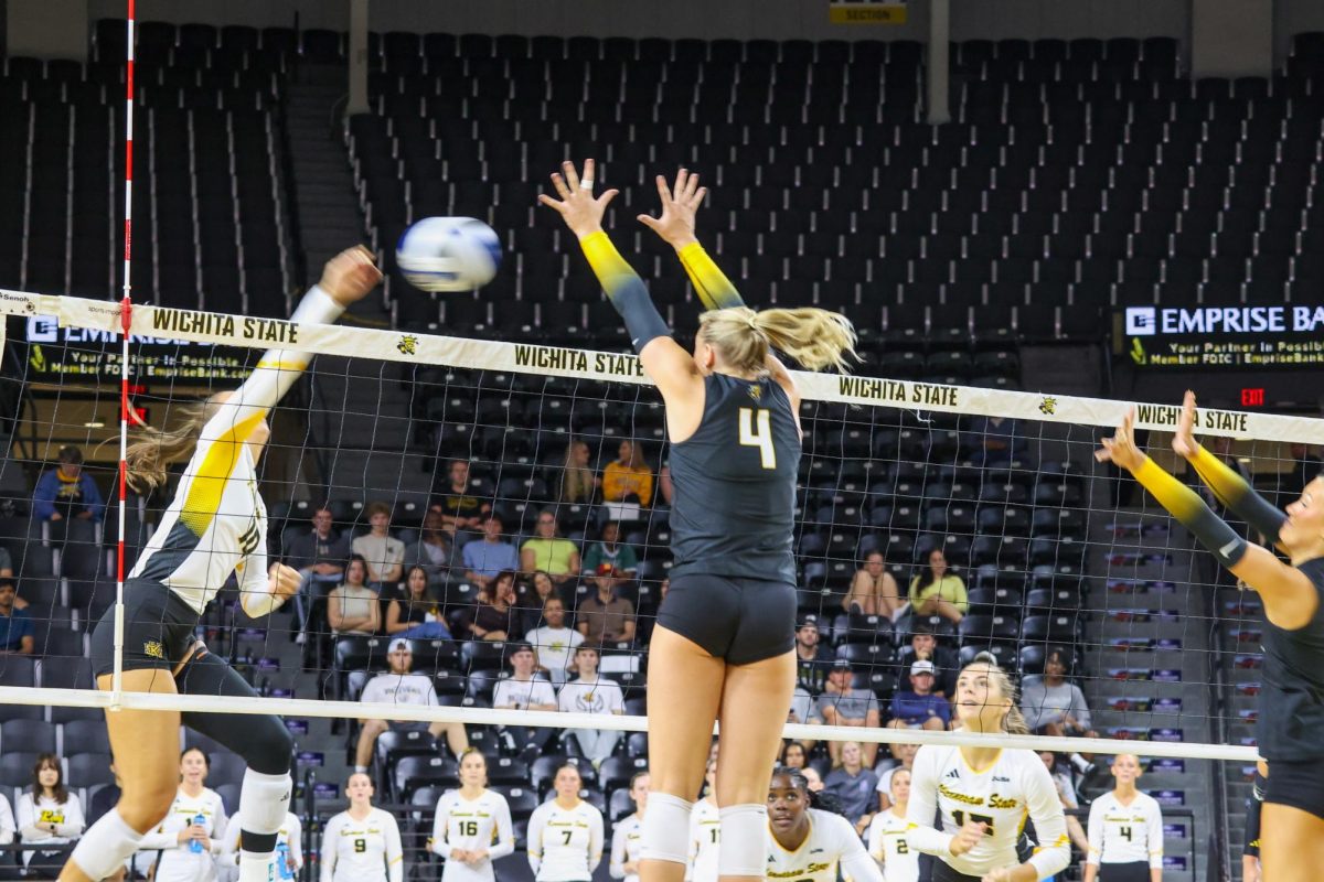 Senior outside hitter Brooklyn Leggett attempts block the ball from going over the net. The Shockers had seven blocks in the 3-0 loss on Aug. 29.