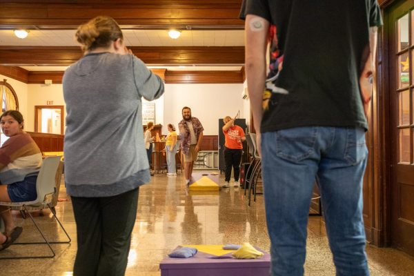 Sophomore Gabe Cornwell tosses a bean bag during a game of cornhole. Originally, the picnic was supposed to take place on the front lawn of Wilner Auditorium.