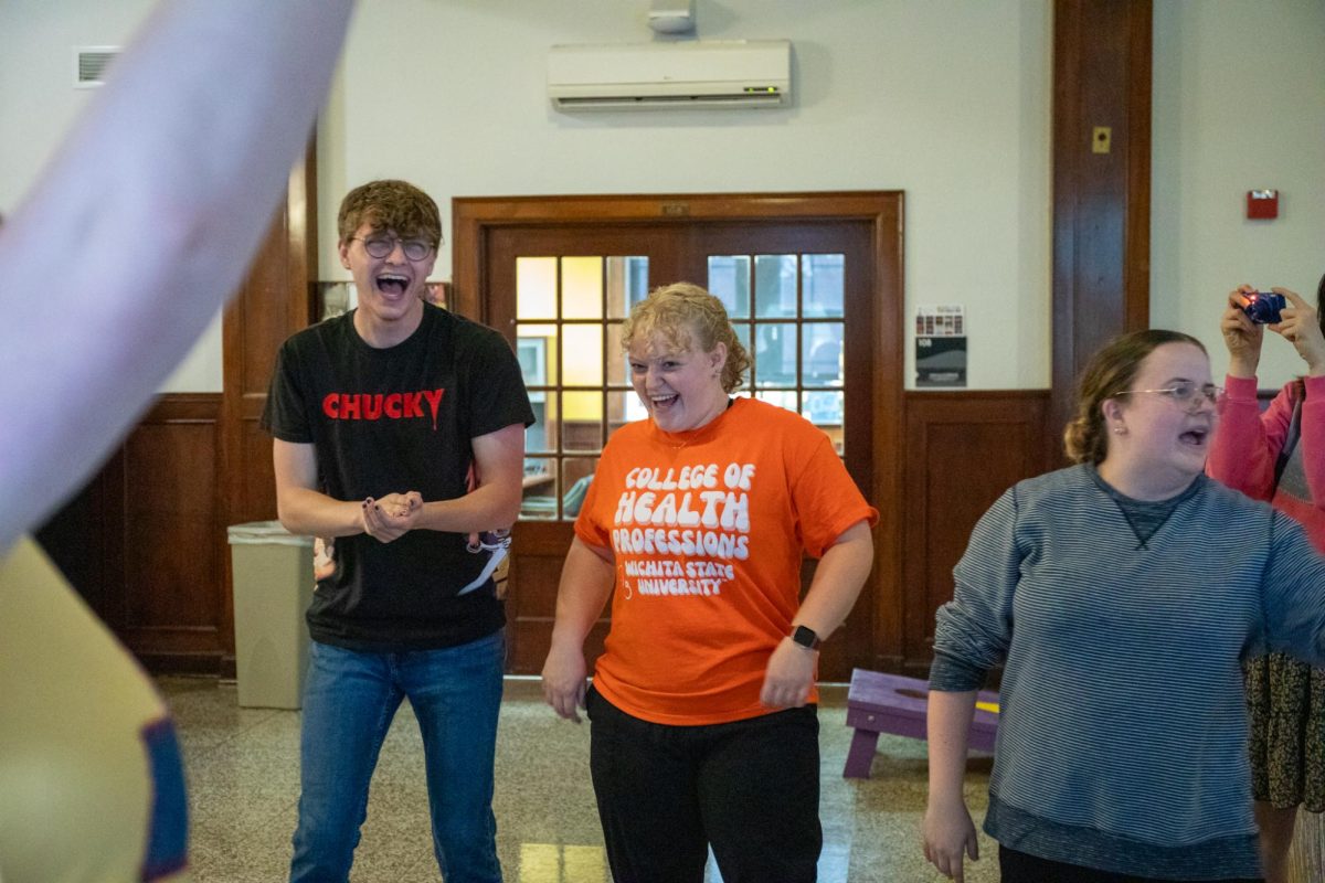 Sophomores Riley Johnsen and Emily Streeter sharing a laugh after a student misinterprets the rules of the theatre game Wah!  Wah! is a game where players gather in a circle and are chosen to be "it" by one player joining their hands together above their head and making eye contact with them while saying "Wah!" That player must then reciprocate that gesture and say "Wah!" Then the players on each side of that person but make a chopping motion with their hands together shouting "Wah!" toward that player.