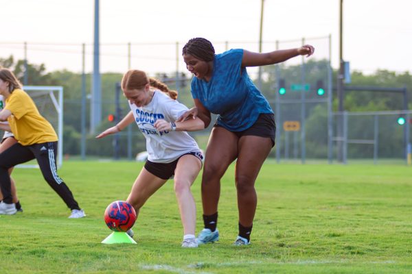Bre Leach (right) and her warm up partner fight to defend the ball during women's soccer club practice on Sept. 4. The club is a way for Wichita State women to continue playing soccer, stay in shape or try a new sport in college.