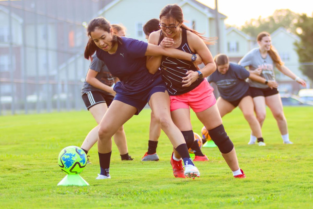 Angeles Perez (left) and her warm up partner practice defending the ball during women's soccer club practice on Sept. 4. The women's soccer club provides a sense of community for students.