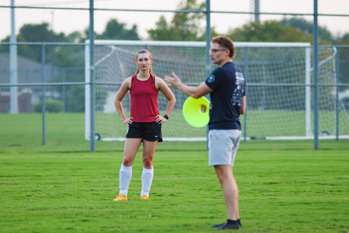 Junior Adrian Allen listens to Wichita State's women's soccer club coach give tips during a scrimmage on Sept. 4. Allen is a film major.