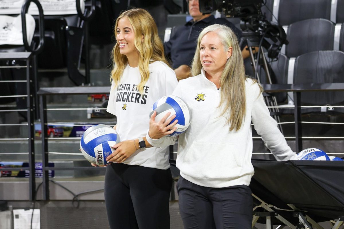 Sophomore outside hitter Gracie Morrow (left) smiles from the sidelines during a game against Arkansas on Aug. 31.  “We love each other, and it’s rare," Morrow said. "All of us really care so much for each other and that’s really special.”