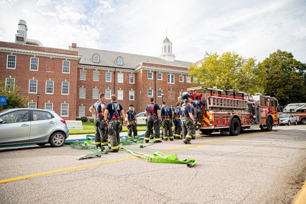 Wichita Fire Department Firefighters pack up hoses after determining the fire was extinguished. The fire took place in room 301 of McKinley Hall.