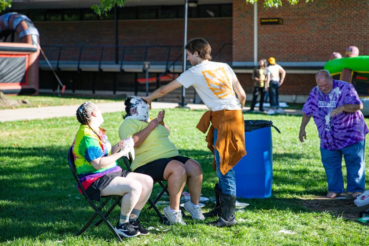 Junior Tyler Troyer hits Lead Success Coach Stefanie Coronado with a pie. The event was held in and around the Rhatigan Student Center.