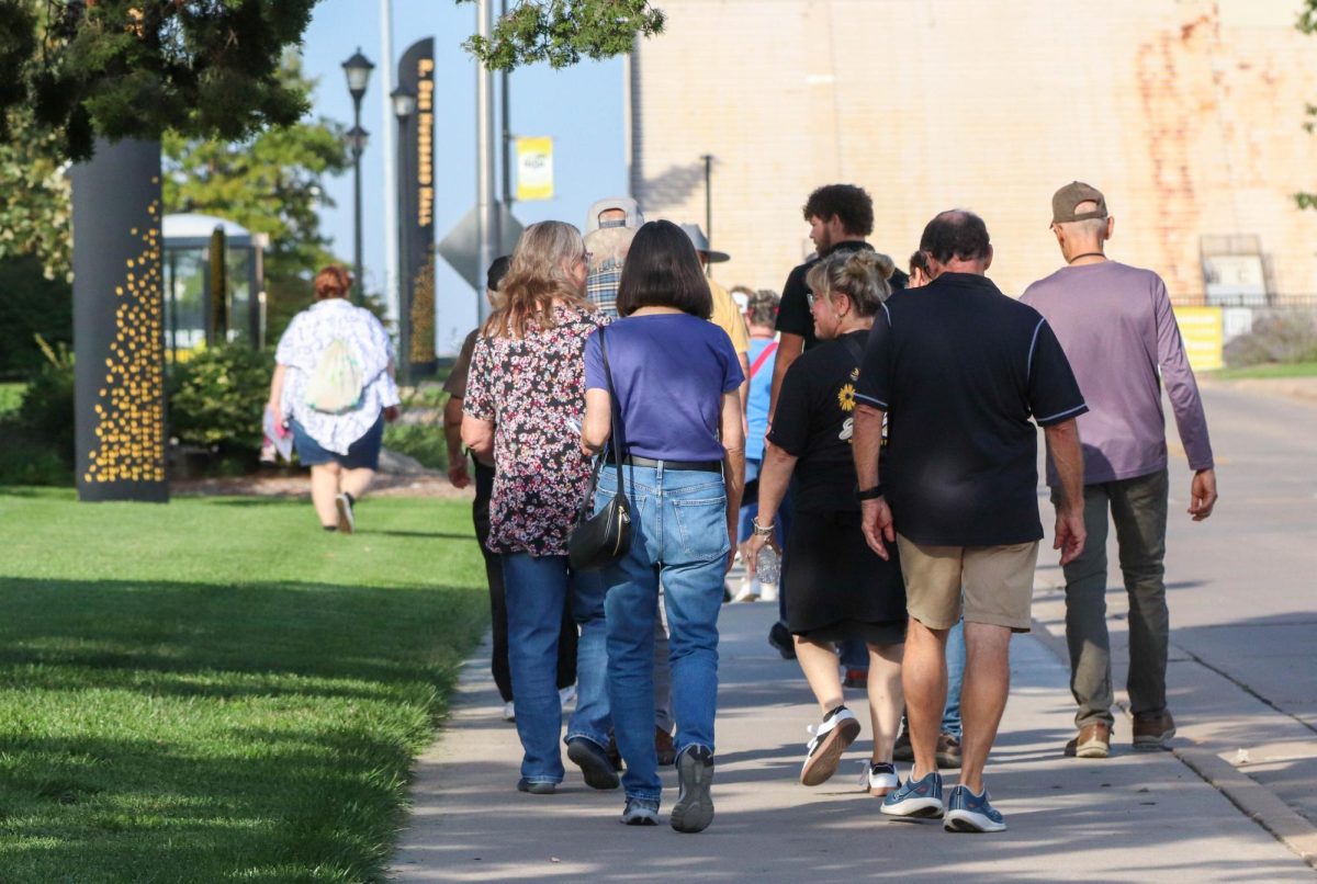 Wichita State walking tour attendees make their way to Cessna Stadium on Sept. 27. The tour began at Braeburn Square.