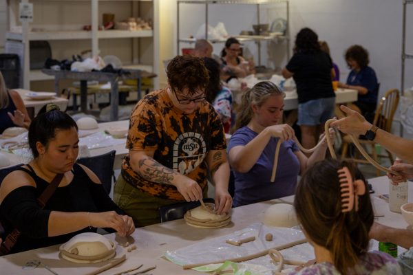 Participants use clay to make a bowl on Sept. 13. Attendees had the option of either building or painting.
