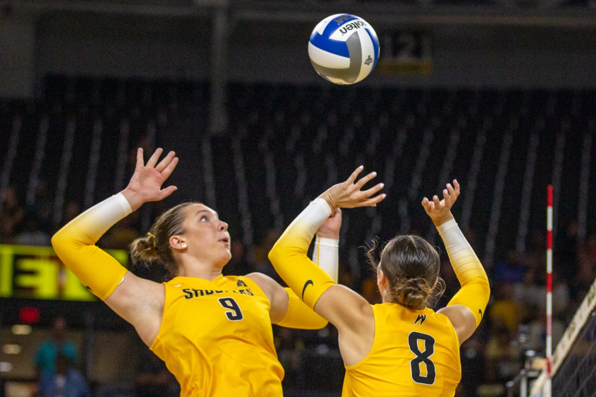 Juniors Elinor Engel and Hannah Hawkins team up for an attack against No. 17 Kansas. Engel made four kills in the 3-0 loss on Sept. 16.