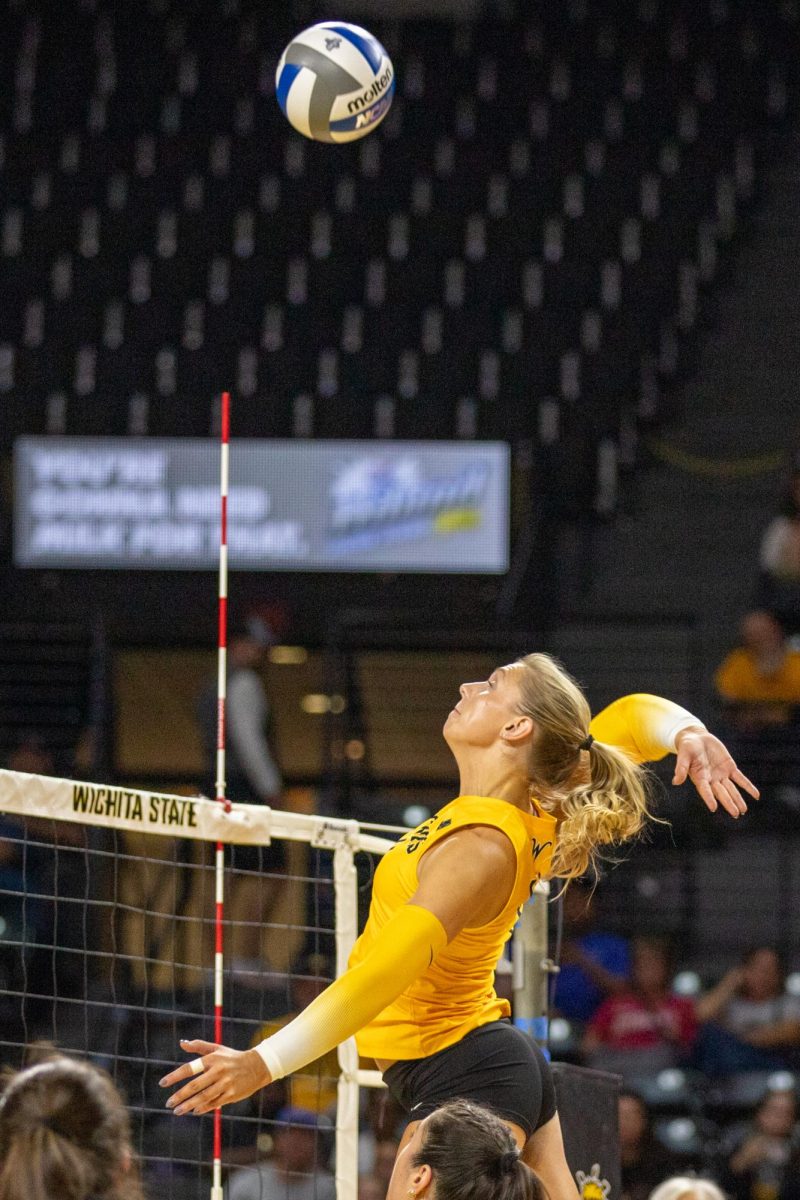 Senior Brooklyn Leggett jumps to spike the ball against No. 17 Kansas on Sept. 16. Leggett made five kills against the Jayhawks.