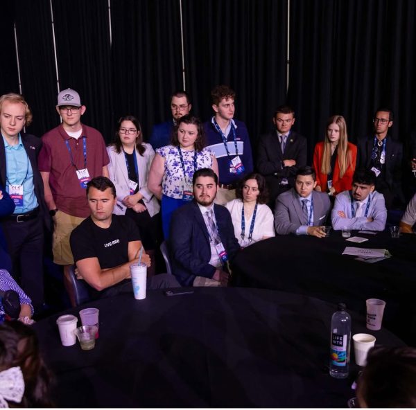 Turning Point USA members at a TPUSA event. WSU TPUSA Chapter President Ryan Whalen is third from the right standing. Charlie Kirk is farthest left sitting. Photo courtesy of Ryan Whalen. 