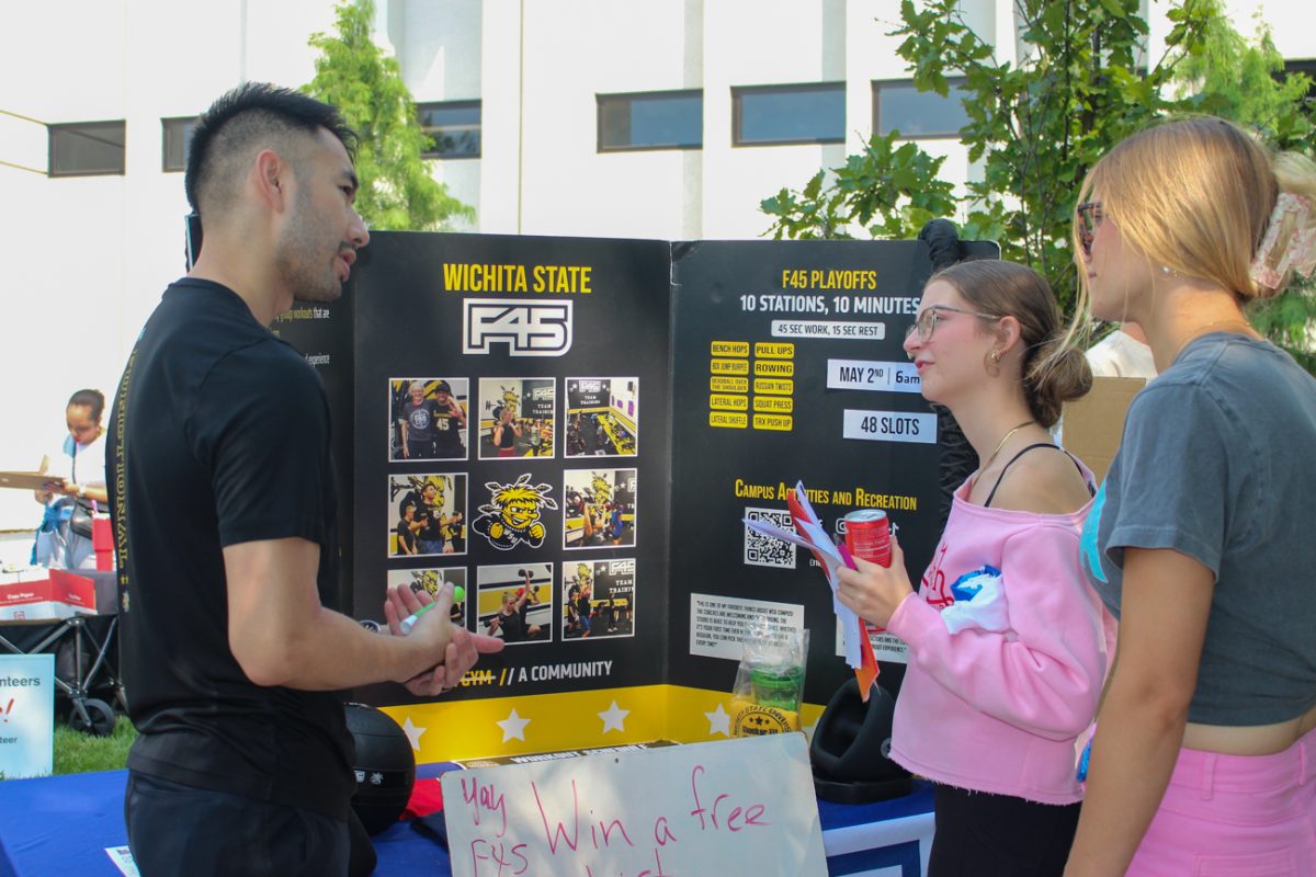 A member of Wichita State's F45 student organization talks to other students about the organization. The office of Student Engagement and Belonging hosts Involvement Fair every year. 