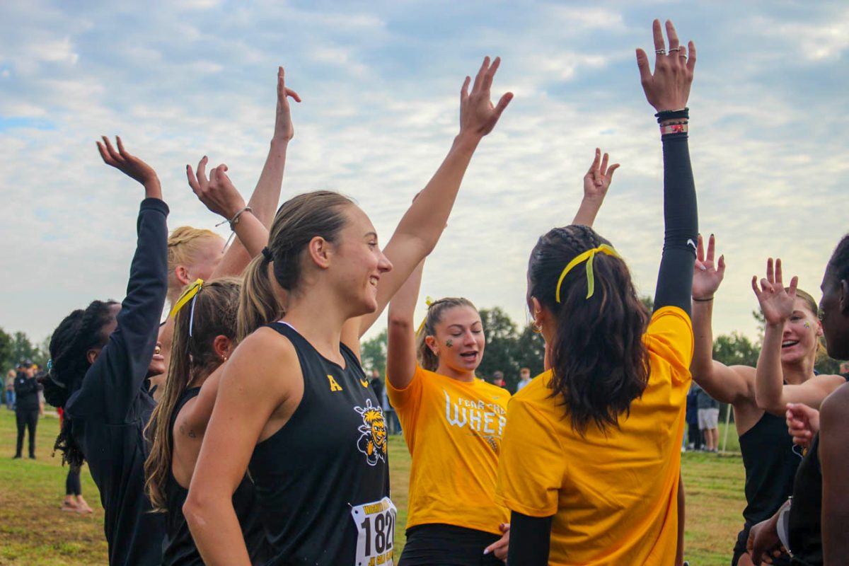 Wichita State's women's cross country team huddles at the JK Gold Classic on Sept. 6. The Shockers placed third in the women's 5-kilometer race.