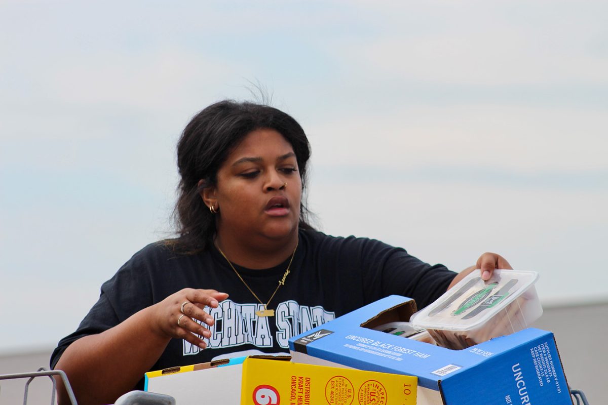 Student Governance Coordinator Lauren Madison unloads a cart at Sam's Club. The group purchased food to donate to the Shocker Support Locker. 