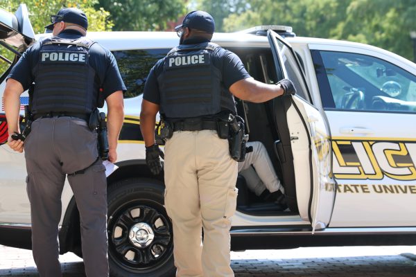 A suspect is taken into custody outside of the Rhatigan Student Center.