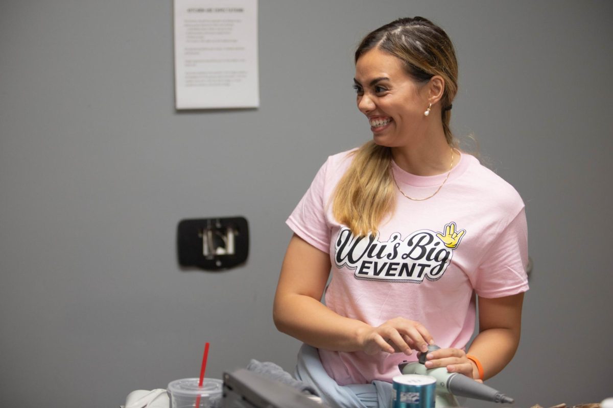 Trinity Rouse smiles after filling a steamer to clean the floors at AbilityPoint. Rouse is a sophomore studying accounting and is in Alpha Phi with Dollarhide.
