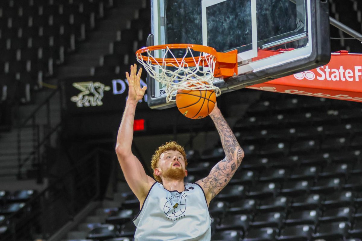 Center Will Berg dunks the ball during practice on Sept. 18. Berg is tied for the tallest athlete in program history, measuring in at 7-foot-2.