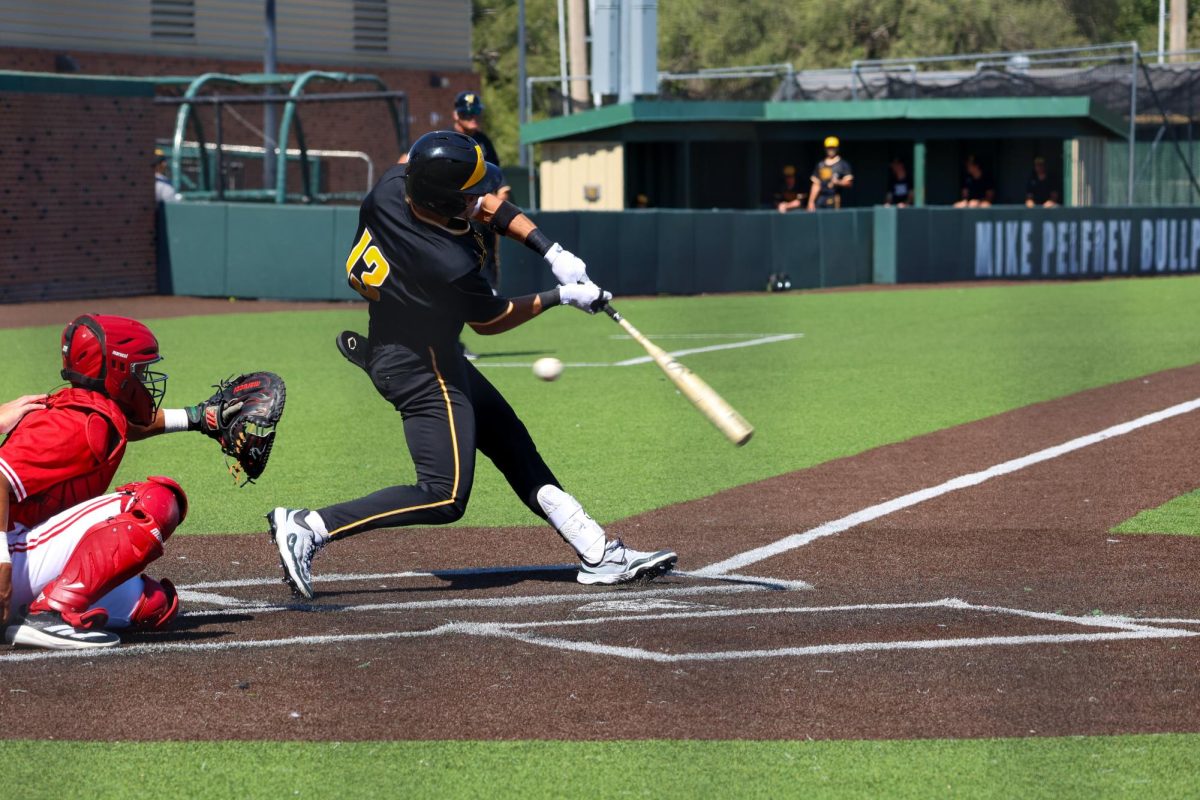 Senior Drew Bugner (13) swings and misses against Nebraska on Saturday, Sept. 27, 2025, at Eck Stadium in Wichita, Kansas. Bugner hit .407 last season at Pittsburg State in Pittsburg, Kansas.