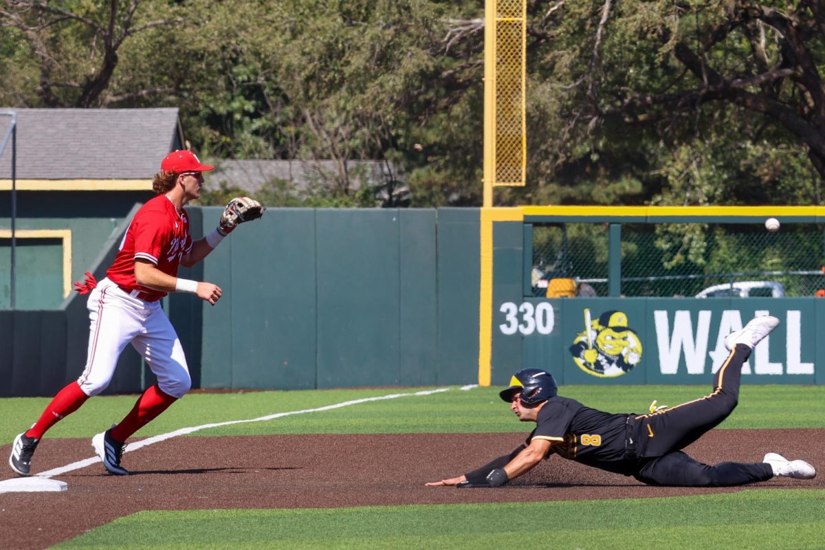 Graduate student Alex Ulloa (8) slides head-first into third base against Nebraska on Saturday, Sept. 27, 2025, at Eck Stadium in Wichita, Kansas. Wichita State and Nebraska held a 16-inning game as part of the fall schedule.