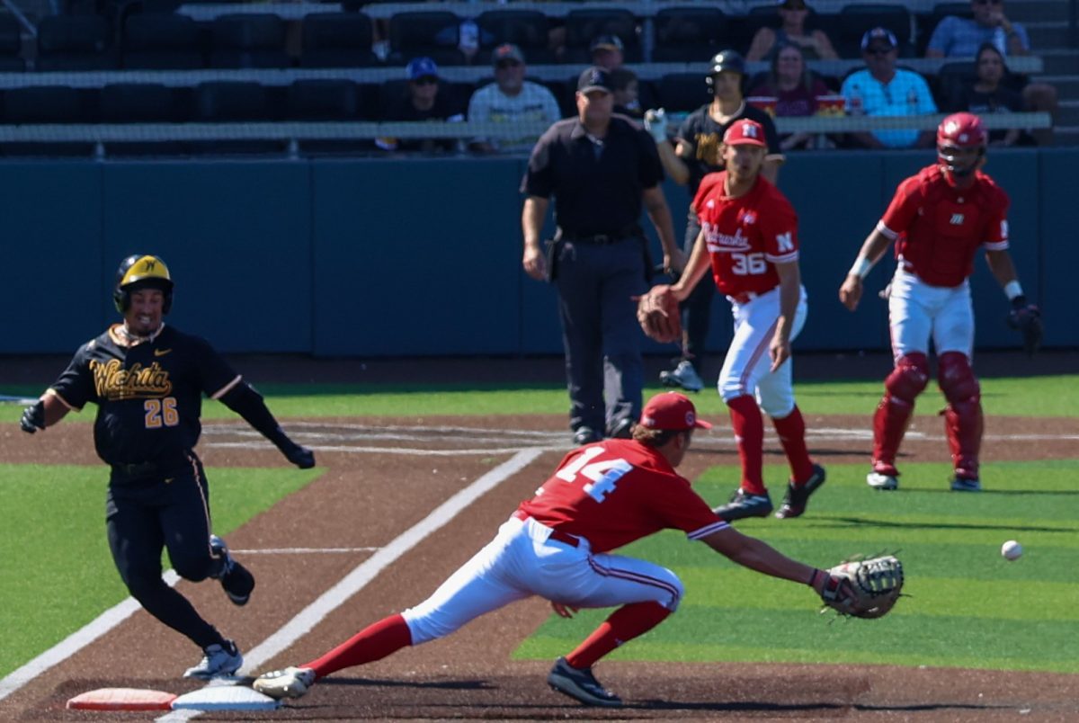 Junior Kaleb Duncan (26) tries to beat out a throw at first base against Nebraska on Saturday, Sept. 27, 2025, at Eck Stadium in Wichita, Kansas. Duncan was called safe on the play.