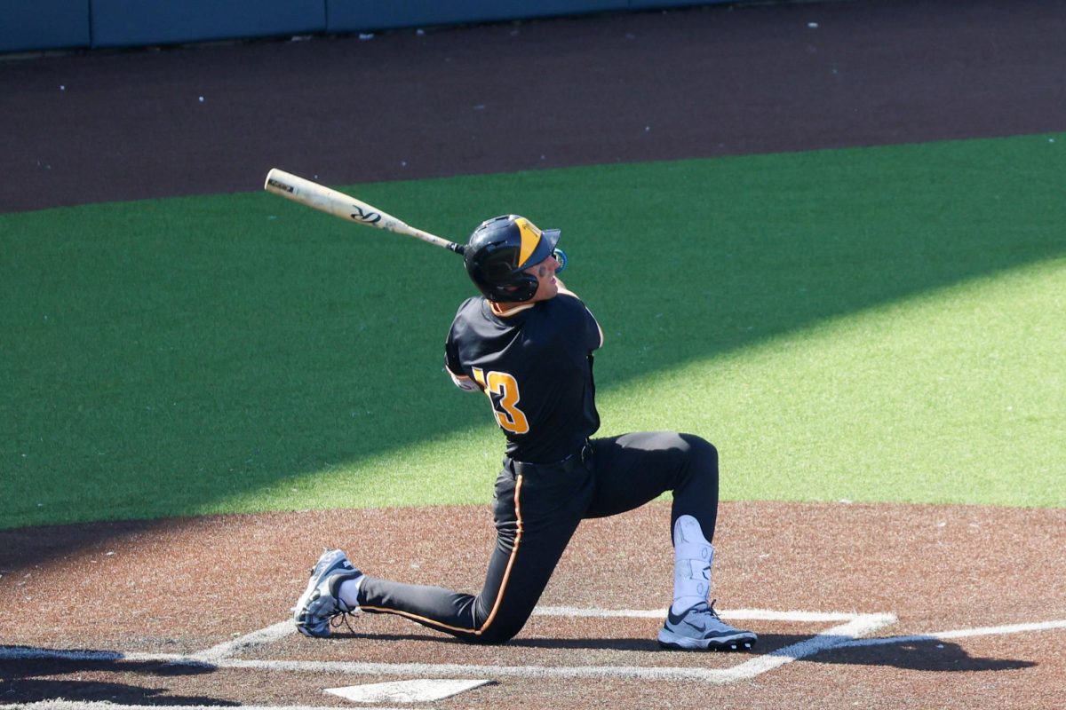 Senior Drew Bugner (13) drops to one knee after swinging the bat against Nebraska on Saturday, Sept. 27, 2025, at Eck Stadium in Wichita, Kansas. Bugner is one of four Wichita natives on Wichita State's baseball team.