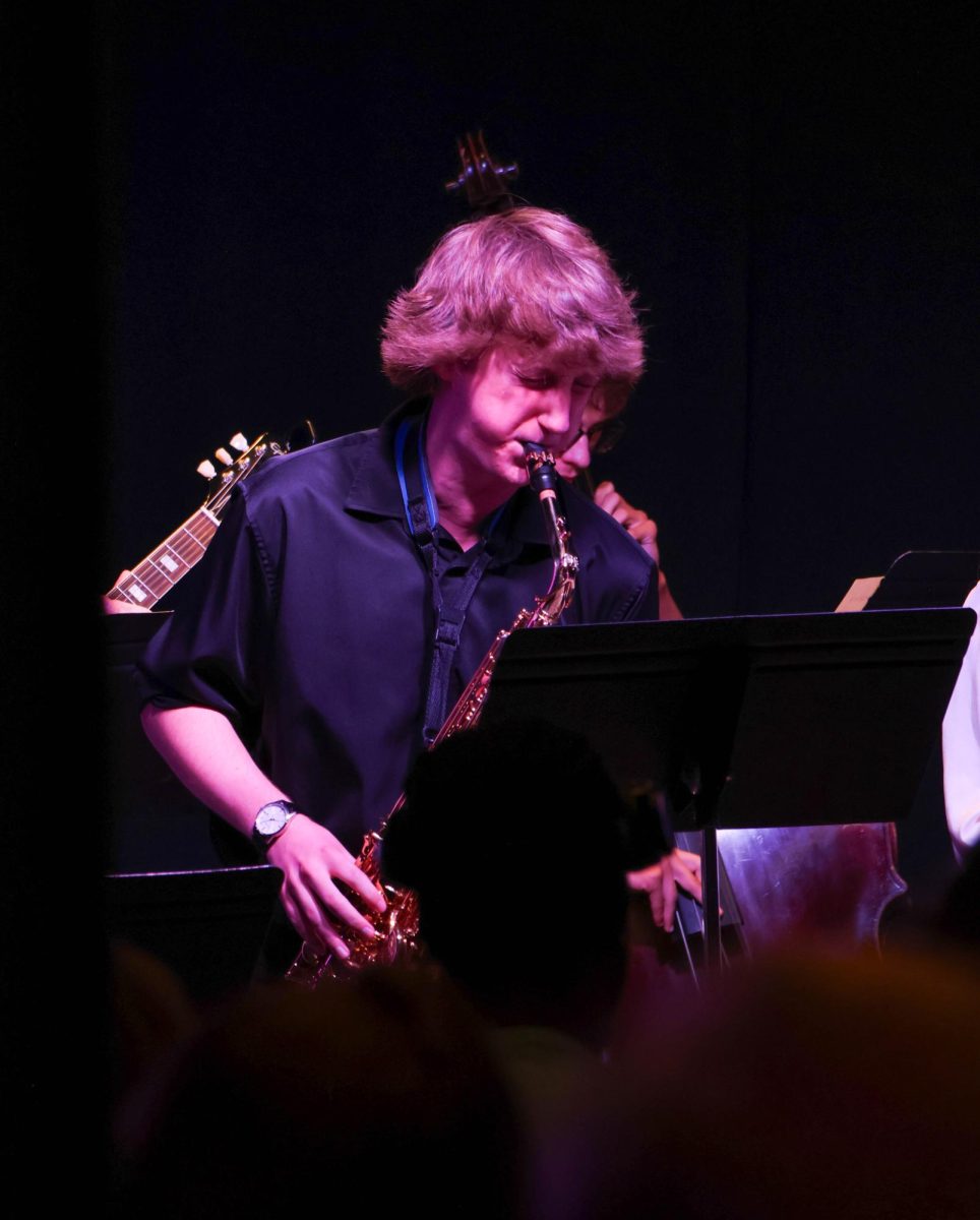 Alto saxophone player Aidan Kinch performs a solo at Walker's Jazz Lounge on Sept. 21. Wichita State's Saxophonics Jazz Ensemble played a set of three songs.