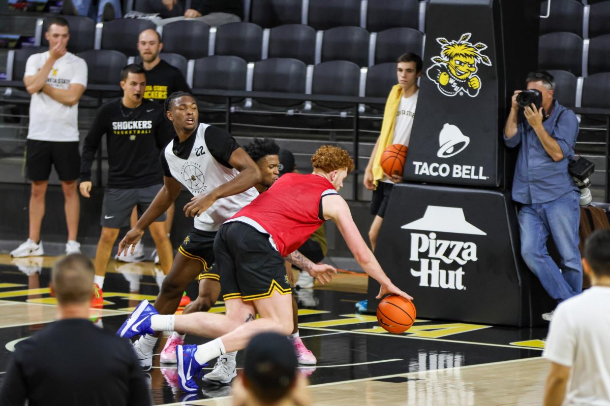 Center Will Berg dribbles the ball into the paint during open practice on Sept. 18. Berg transferred from Purdue after playing as reserve for two seasons.